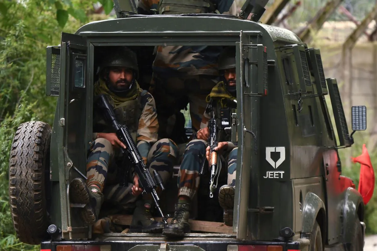 Indian army soldiers keep watch at the back of an army vehicle near the site of a gunbattle at Yadipora village of Pattan area north of Srinagar on Sept. 4, 2020. (Tauseef Mustafa/AFP via Getty Images)