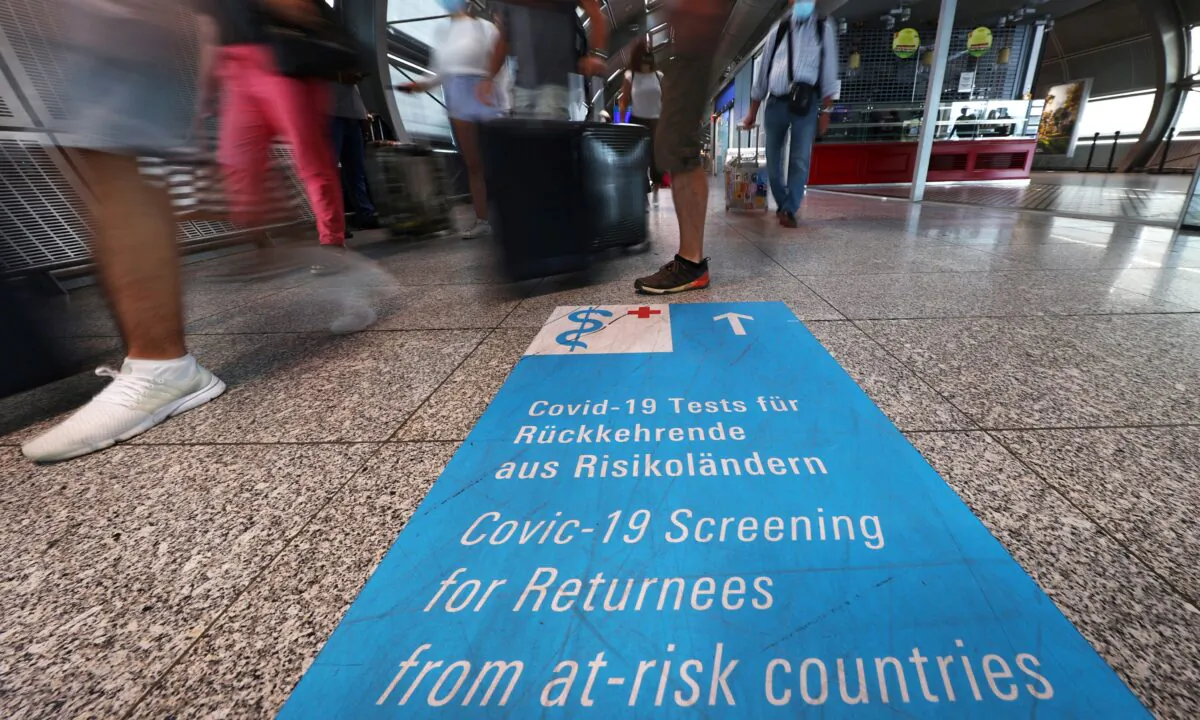 Signs lead the way towards COVID-19 test centers at the airport in Frankfurt, Germany, on Aug. 11, 2020. (Kai Pfaffenbach/Reuters)