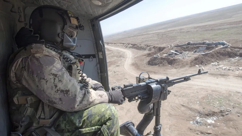 A Canadian Forces door gunner keeps watch as his Griffon helicopter goes on a mission, February 20, 2017 in northern Iraq. (The Canadian Press/Ryan Remiorz)