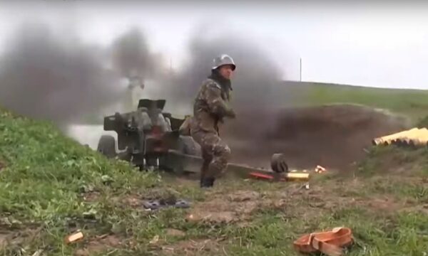 An Armenian serviceman fires a cannon towards Azerbaijan positions