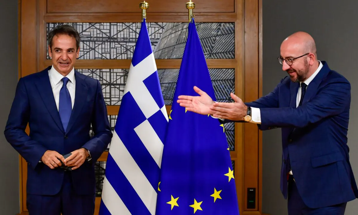 European Council President Charles Michel, right, greets Greek Prime Minister Kyriakos Mitsotakis ahead of a meeting on the sidelines of an European Union summit at the European Council building in Brussels on Oct. 1, 2020. EU leaders are meeting to address a series of foreign affairs issues ranging from Belarus to Turkey and tensions in the eastern Mediterranean. (John Thys/Pool via AP)