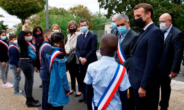 French President Emmanuel Macron speaks to youngsters