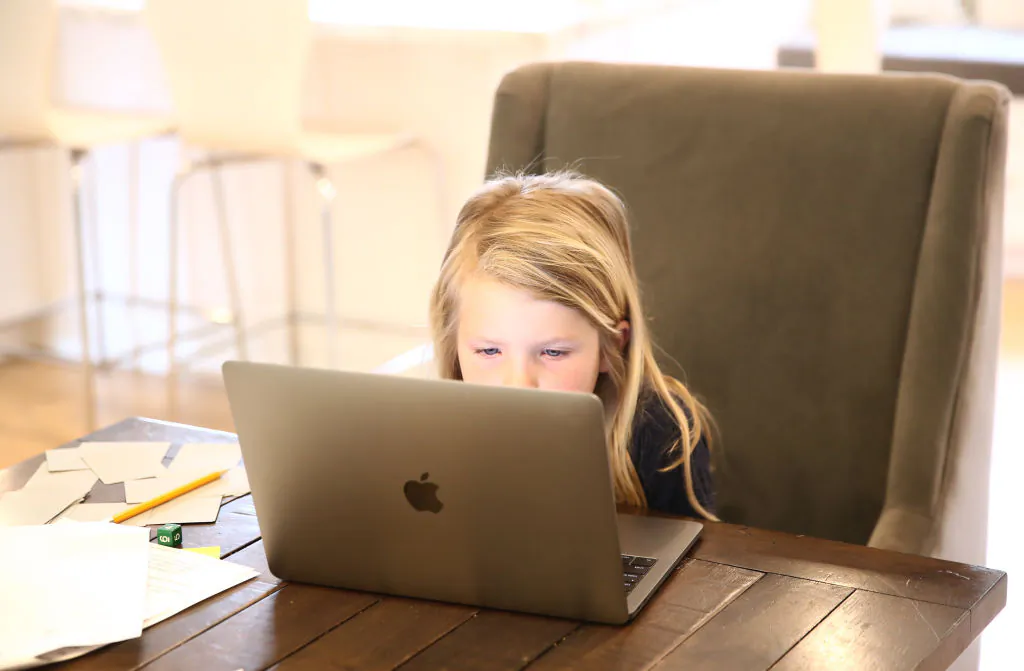 Evianna Van Santvoord, who is in kindergarten, does her schoolwork at home in San Anselmo, Calif., on March 18, 2020. (Ezra Shaw/Getty Images)