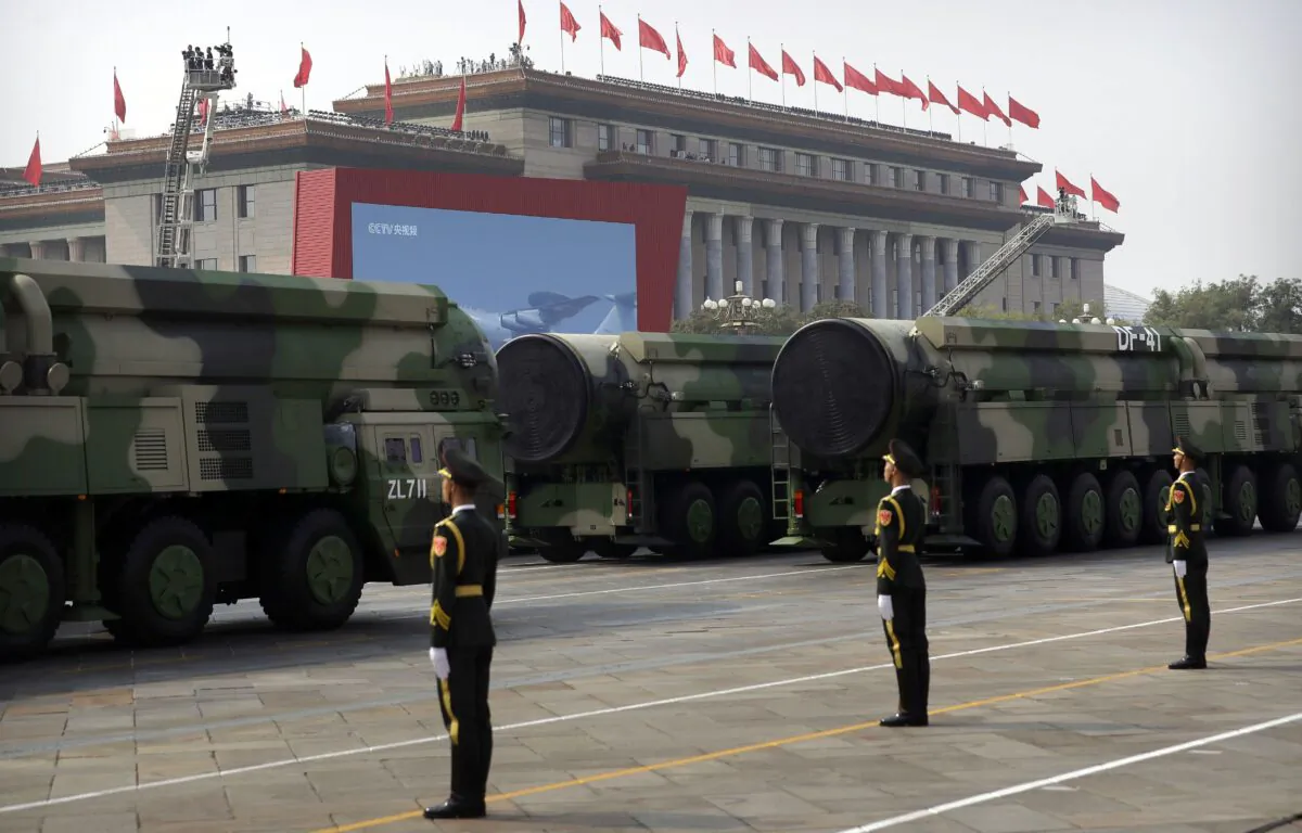 Chinese military vehicles carrying DF-41 ballistic missiles roll past the Great Hall of the People during a parade to commemorate the 70th anniversary of the founding of communist China, in Beijing on Oct. 1, 2019. (AP Photo/Mark Schiefelbein)