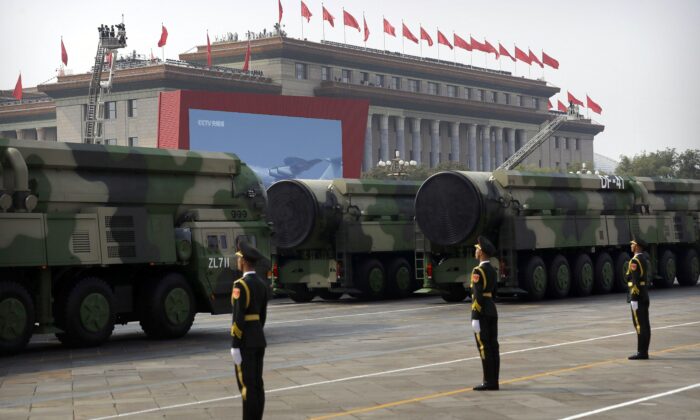 Chinese military vehicles carrying DF-41 ballistic missiles roll past the Great Hall of the People during a parade to commemorate the 70th anniversary of the founding of communist China, in Beijing on Oct. 1, 2019. (AP Photo/Mark Schiefelbein)