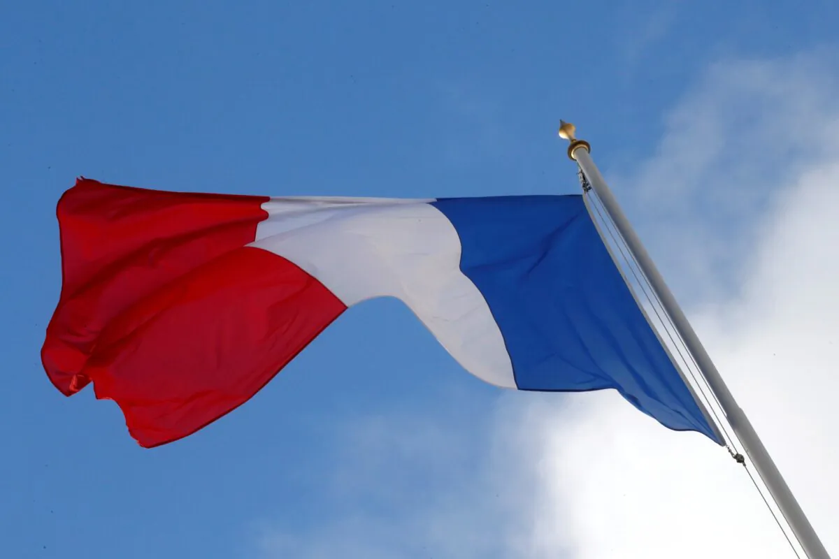 A French flag flutters in the sky over the Elysee Palace in Paris, on Dec. 10, 2018. (Philippe Wojazer/Reuters)