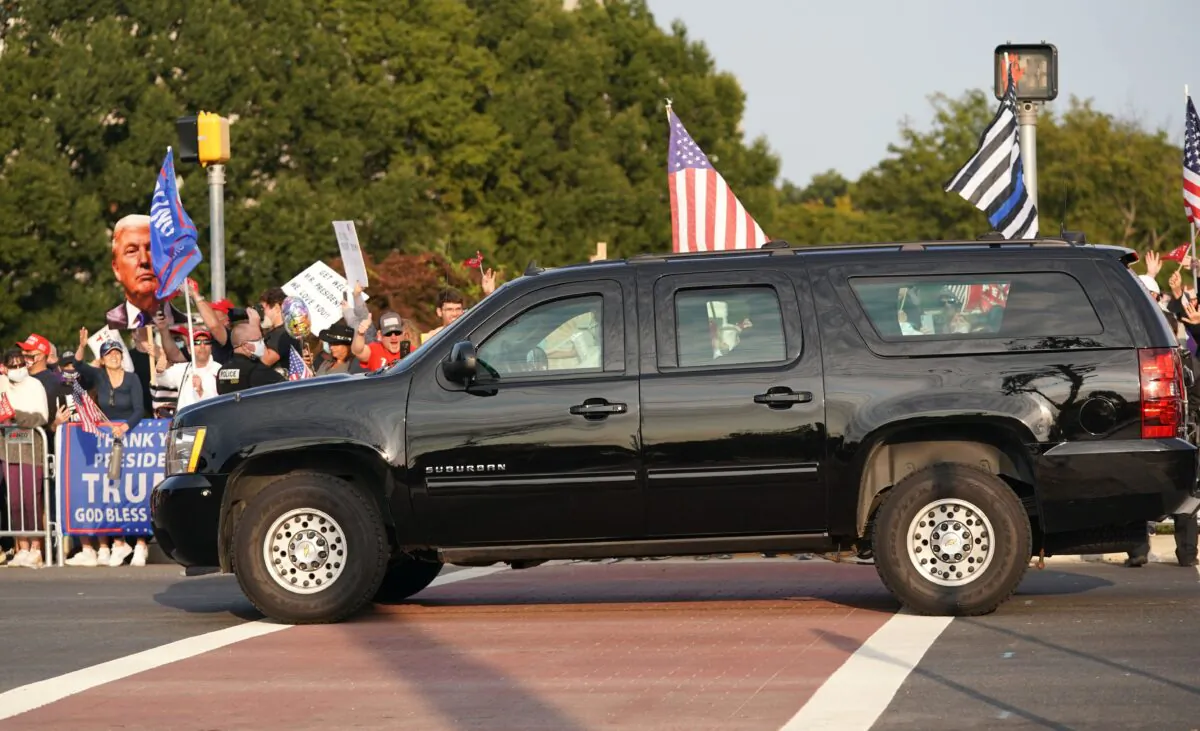 A car with President Donald Trump drives past supporters in a motorcade outside of Walter Reed Medical Center in Bethesda, Md., on Oct. 4, 2020. (Alex Edelman/AFP via Getty Images)