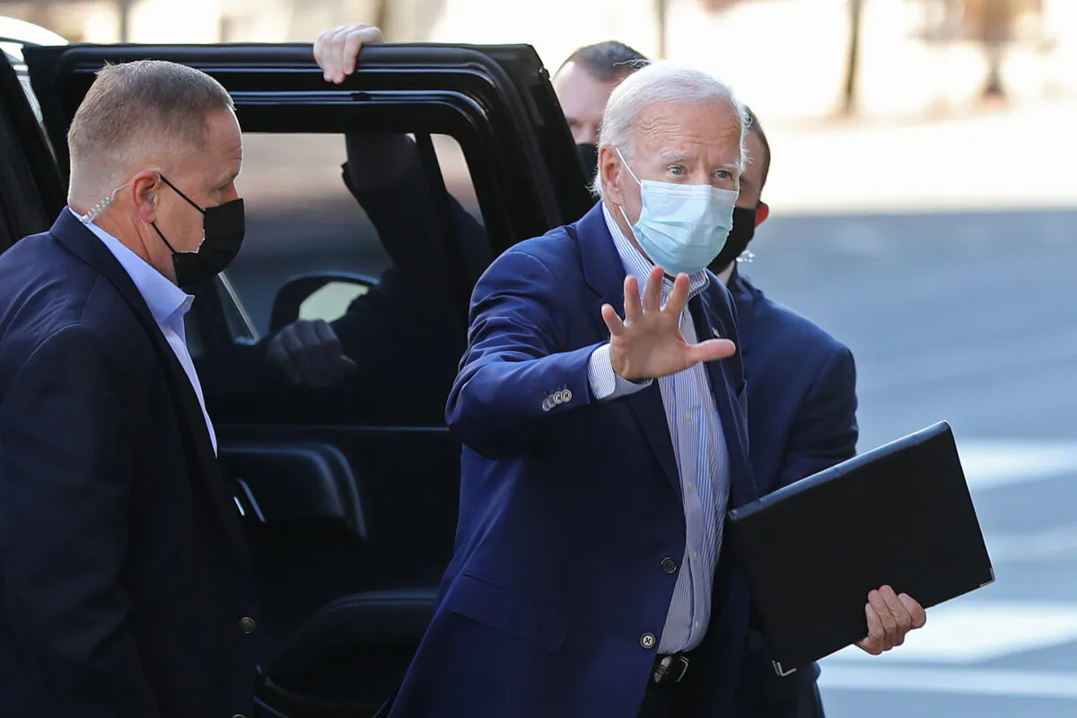 Democratic presidential nominee Joe Biden waves to journalists as he enters the Queen Theater in Wilmington, Del., Oct. 3, 2020. (Chip Somodevilla/Getty Images)