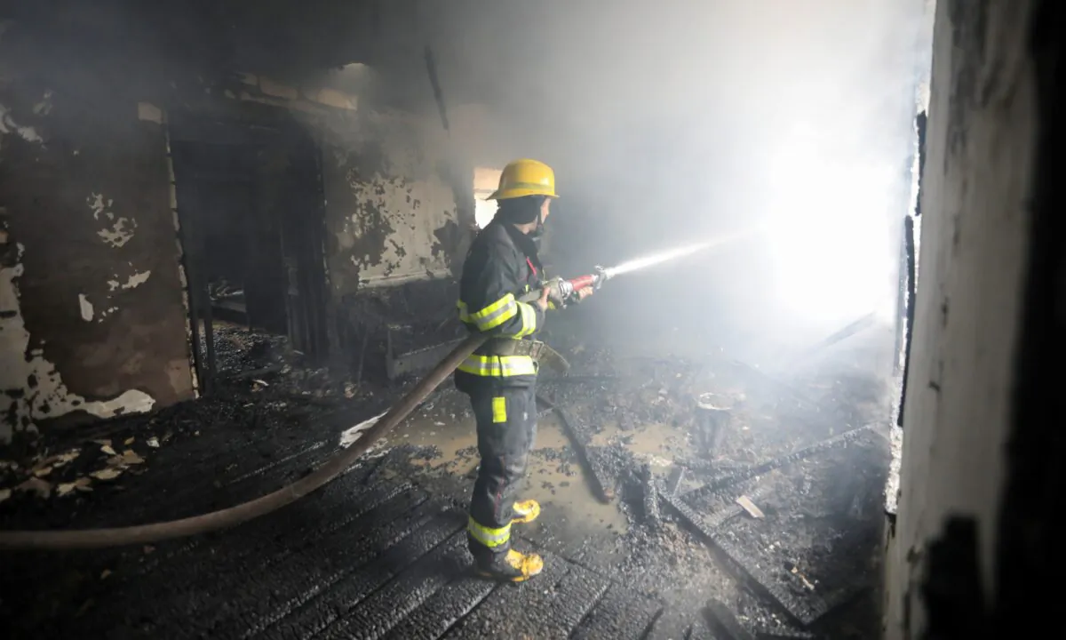 A firefighter extinguishes a fire in a house caused by shelling in the fighting over the breakaway region of Nagorno-Karabakh in the town of Barda, Azerbaijan, on Oct. 5, 2020. (Aziz Karimov/Reuters)
