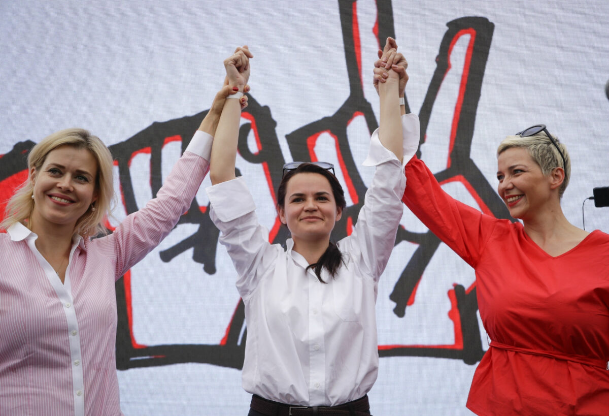 In this July 19, 2020, file photo, Maria Kolesnikova, a representative of Viktor Babariko, right, Sviatlana Tsikhanouskaya, candidate for the presidential elections, center, and wife of non-registered candidate Valery Tsepkalo, Veronika Tsepkalo, left, gesture during a meeting in support of Sviatlana Tsikhanouskaya in Minsk, Belarus. (Sergei Grits/AP Photo, File)