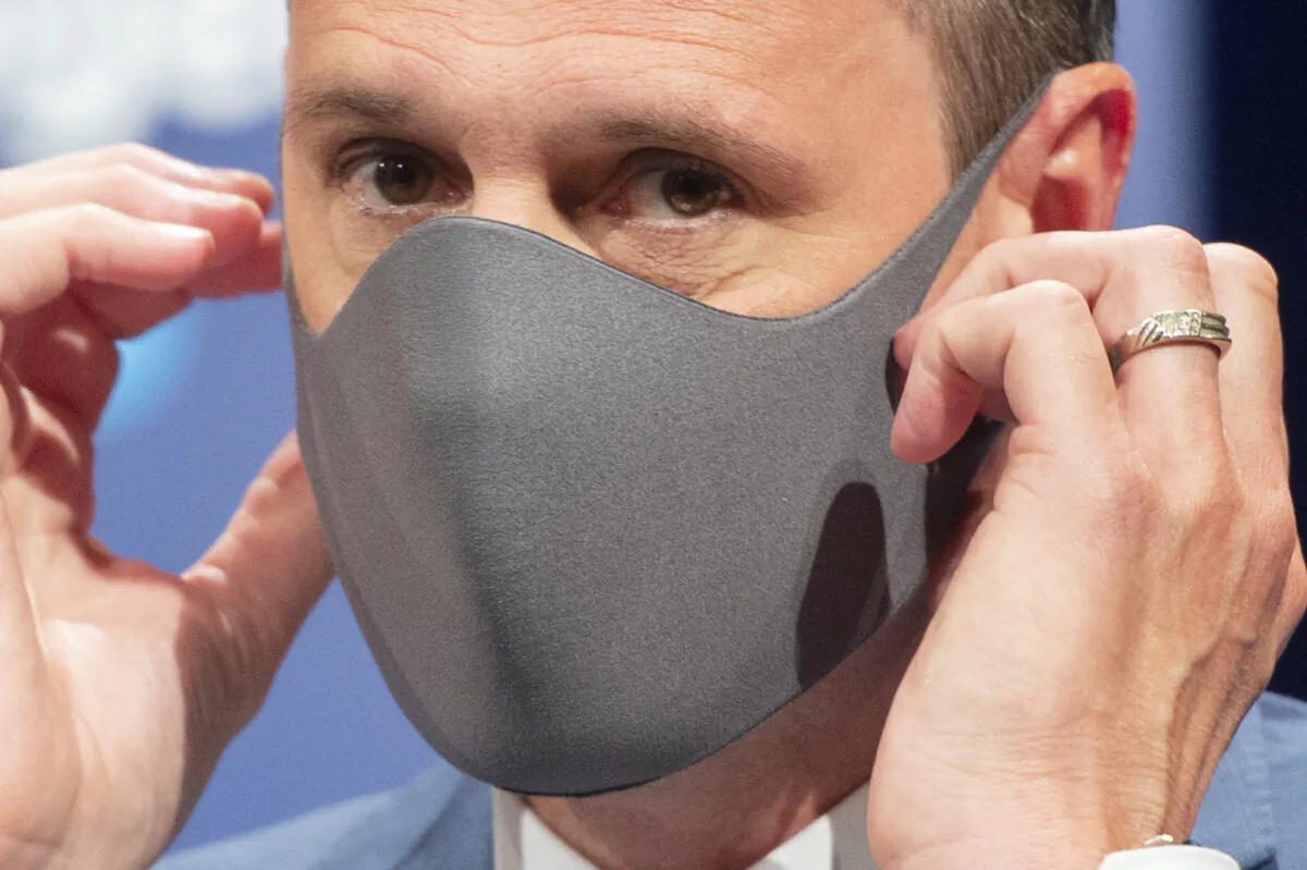 Quebec Education Minister Jean-Francois Roberge  puts on his face mask after unveiling an updated back-to-school plan for the 2020-2021 school year at a news conference in Montreal, Canada on Aug. 10, 2020. (Ryan Remiorz/The Canadian Press)