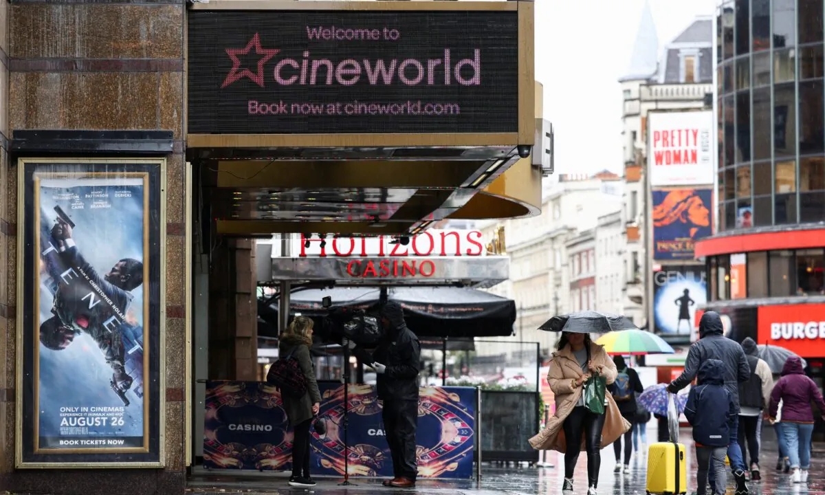 People walk past a Cineworld cinema in Leicester Square in London, on Oct. 4, 2020. (Henry Nicholls/Reuters)