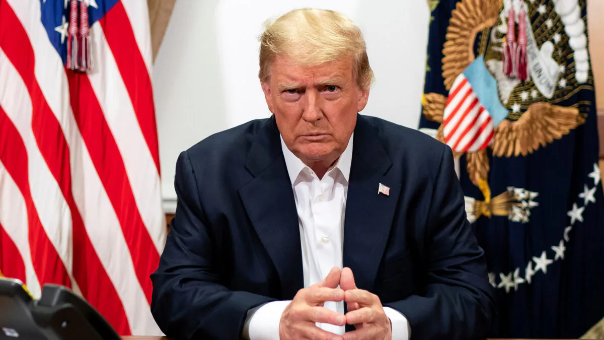 U.S. President Donald Trump listens during a phone call with Vice President Mike Pence, Secretary of State Mike Pompeo, and Chairman of the Joint Chiefs of Staff Gen. Mark Milley, in his conference room at Walter Reed National Military Medical Center in Bethesda, Md., on Oct. 4, 2020. (Tia Dufour/The White House via AP)