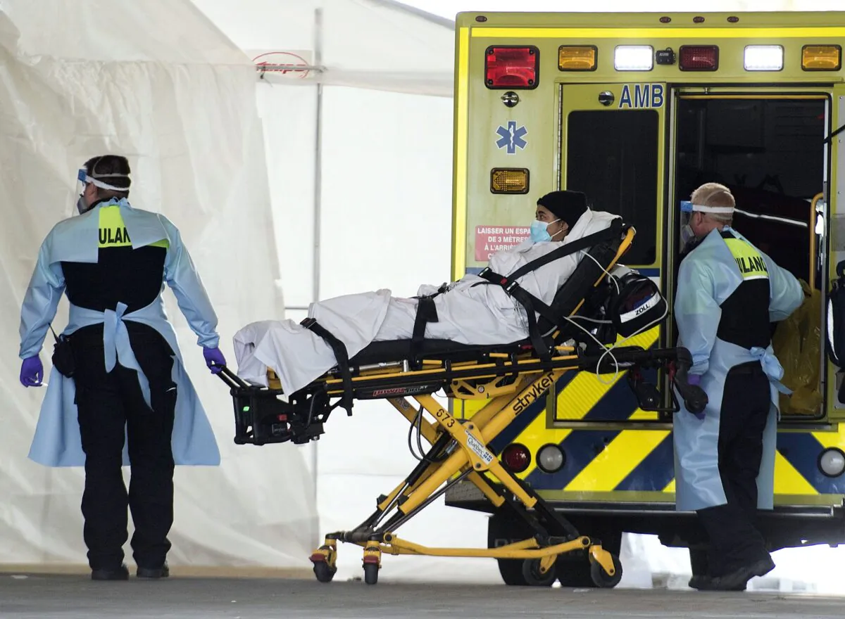 Paramedics transfer a patient from an ambulance to the LaSalle Hospital in Montreal on April 25, 2020, at the height of the pandemic. (The Canadian Press/Graham Hughes)