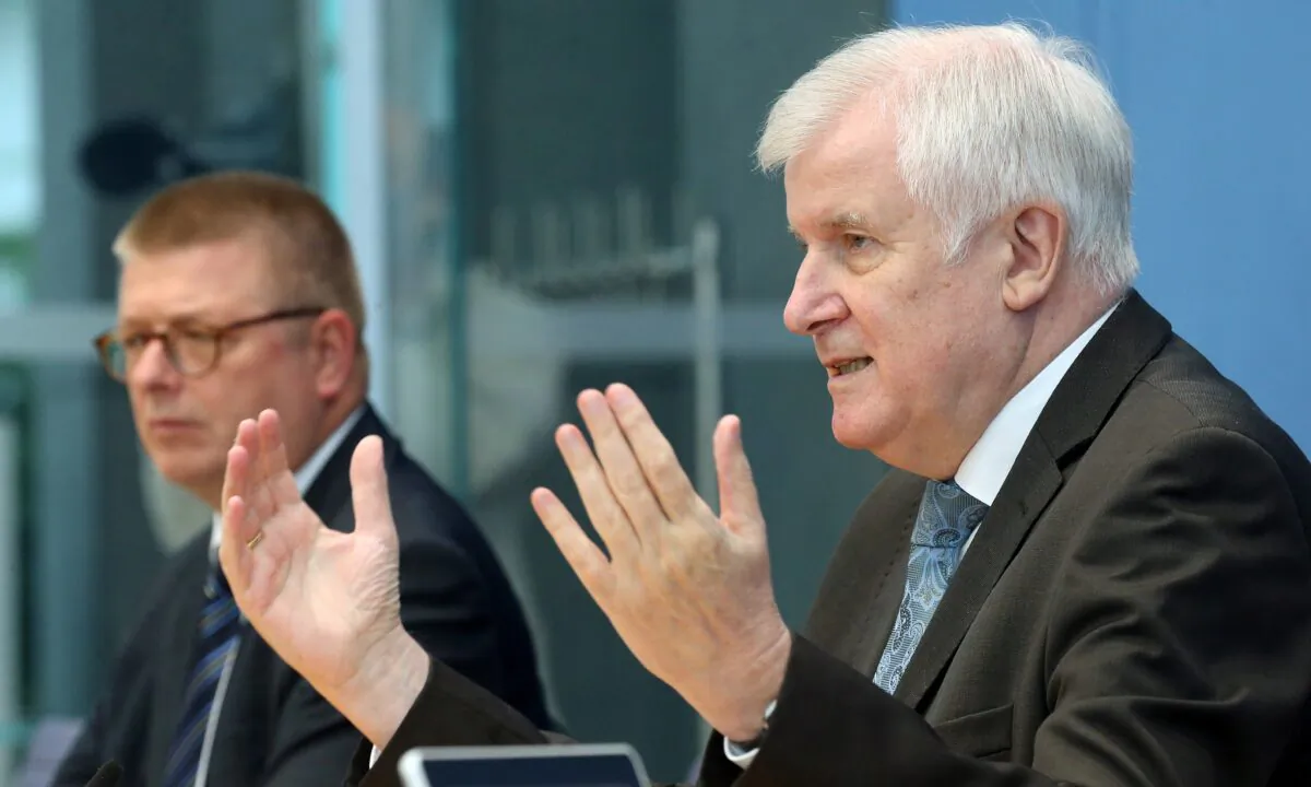 Thomas Haldenwang, president of Germany's Federal Office for the Protection of the Constitution (left) and German Interior Minister Horst Seehofer (right) address a news conference on extremism in Berlin, Germany, on Oct. 6, 2020. (Wolfgang Kumm/Pool via Reuters)