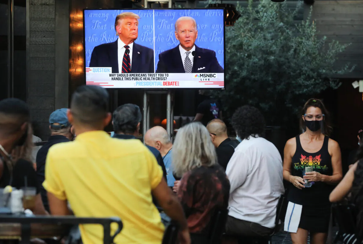 People sit and watch a broadcast of the first debate between President Donald Trump and Democratic presidential nominee Joe Biden at The Abbey in West Hollywood, California, on September 29, 2020. (Mario Tama/Getty Images)