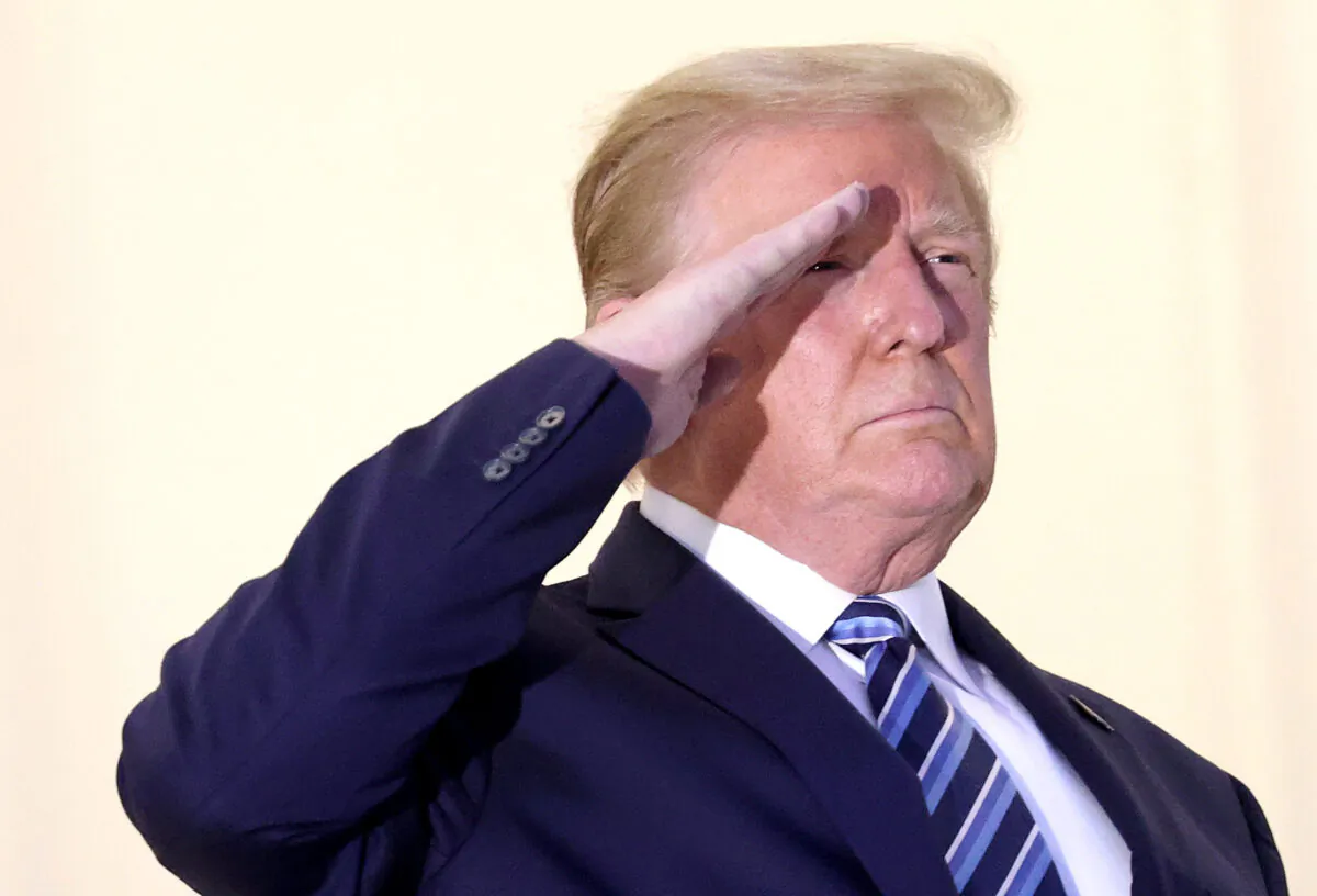 President Donald Trump salutes Marine One helicopter pilots after returning from Walter Reed National Military Medical Center, at the White House in Washington on Oct. 5, 2020. (Win McNamee/Getty Images)