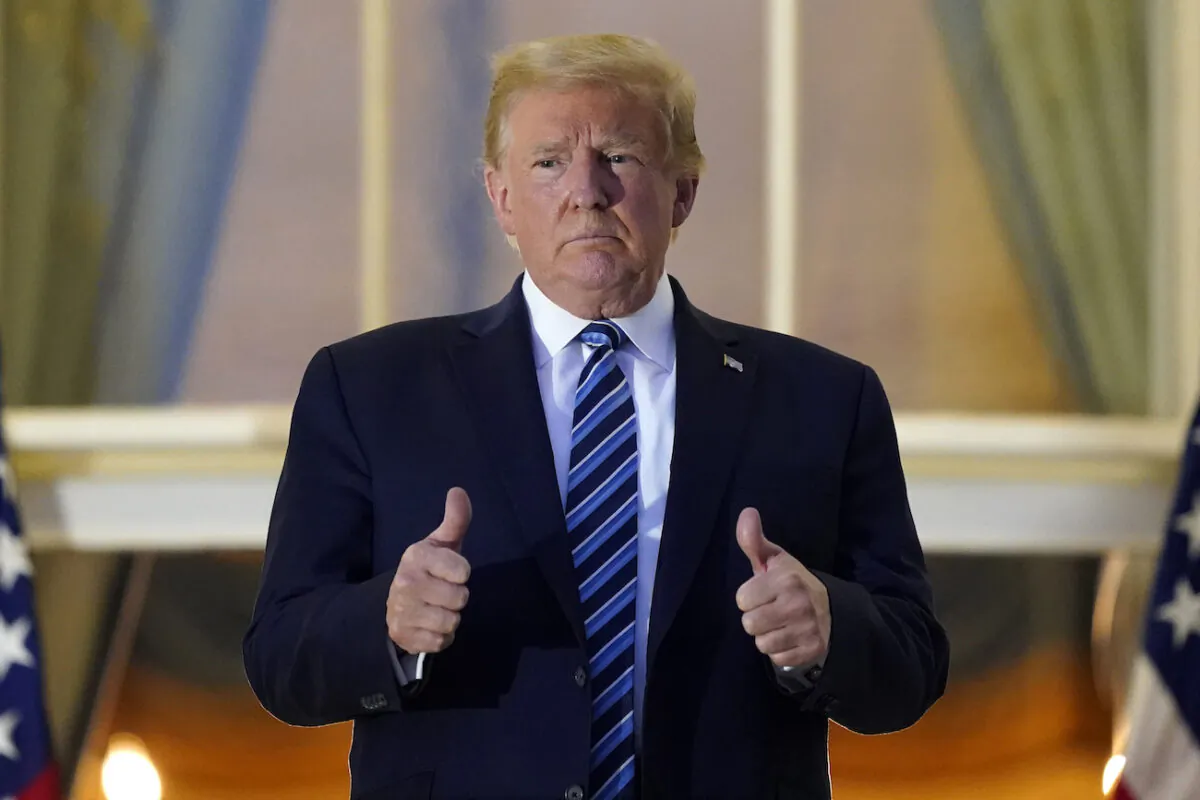 President Donald Trump stands on the balcony outside the Blue Room after returning to the White House in Washington on Oct. 5, 2020. (Alex Brandon/AP Photo)
