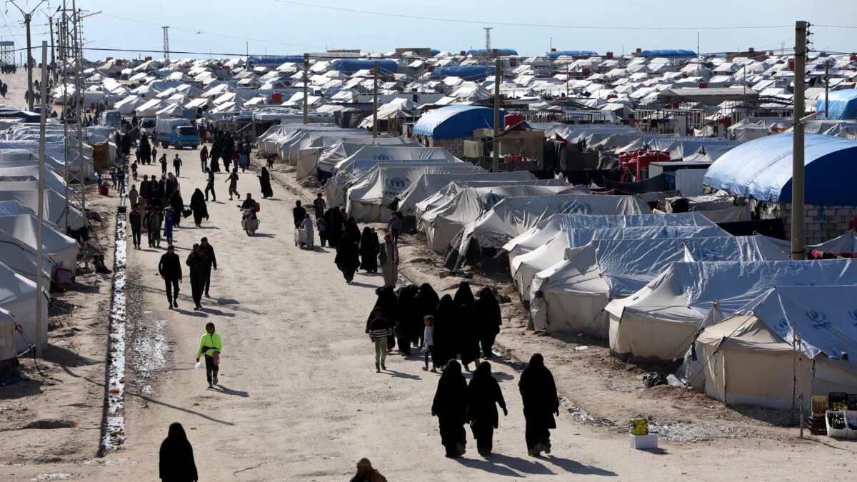 Women walk through al-Hol displacement camp in Hasaka governorate, Syria on April 1, 2019. (Ali Hashisho/Reuters)