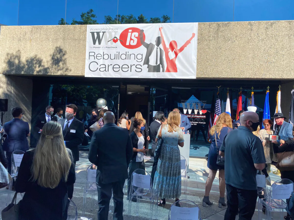 A crowd lingers following the reopening of the Working Wardrobes, a center that provides clothing and training to the needy, in Santa Ana, Calif., on Sept. 30, 2020. (Jack Bradley/The Epoch Times)