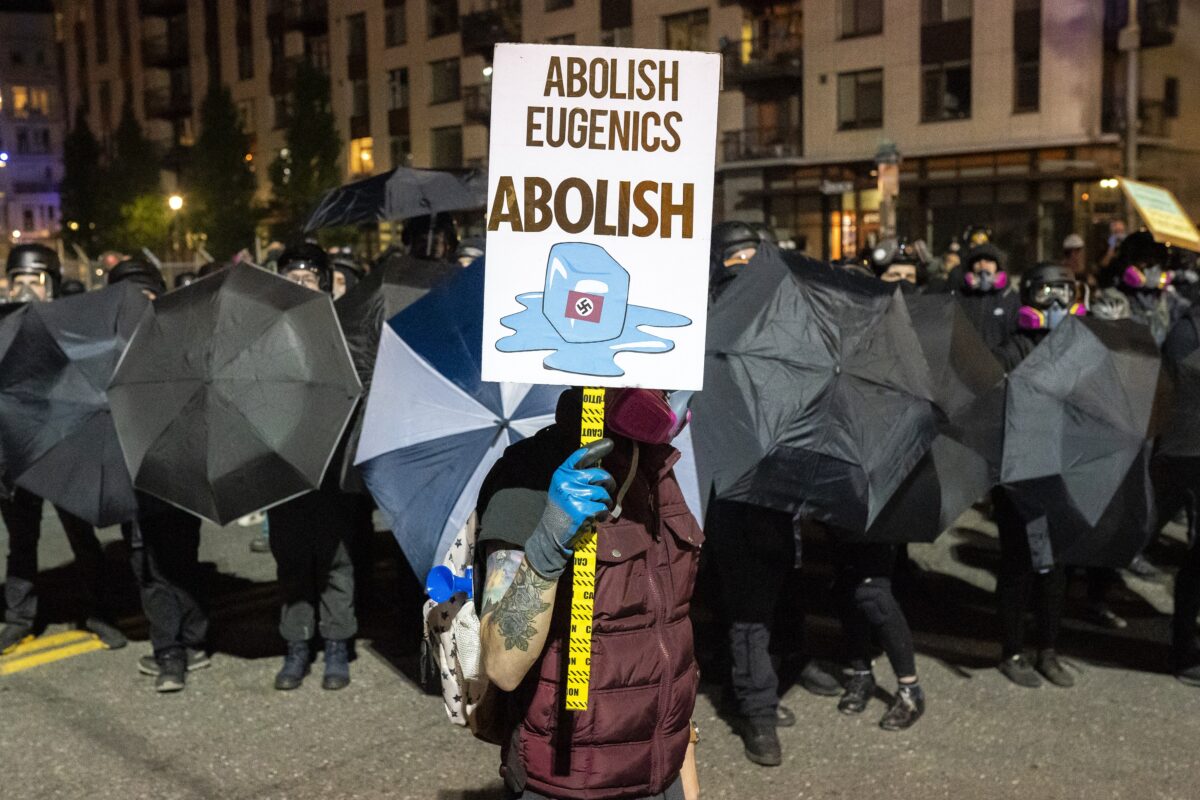 A person holds a sign while marching in Portland, Ore., on Oct. 6, 2020. (Nathan Howard/Getty Images)