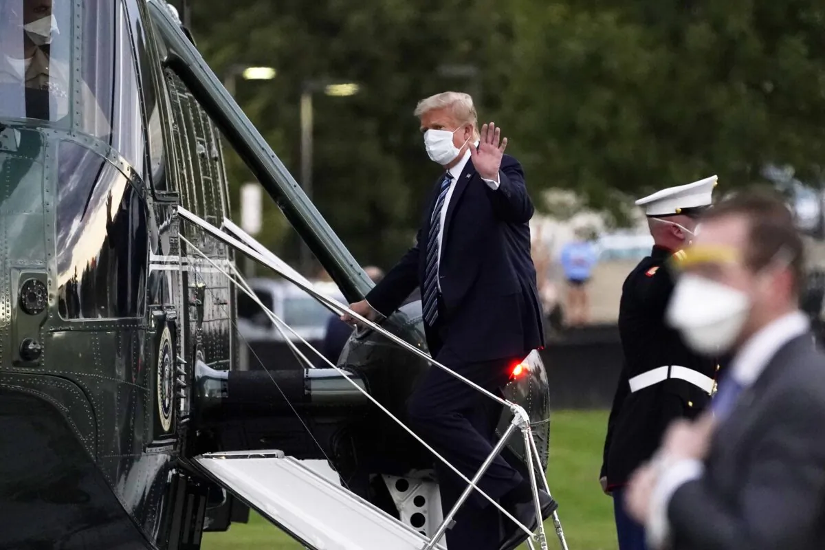 President Donald Trump boards Marine One at Walter Reed National Military Medical Center after receiving treatment for COVID-19, in Bethesda, Md., Oct. 5, 2020. (Evan Vucci/AP Photo)