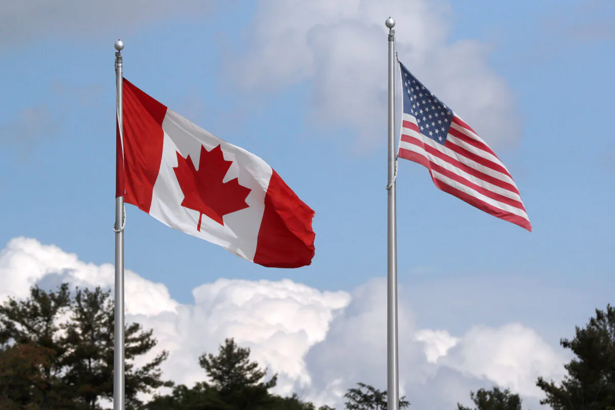  A U.S. and a Canadian flag flutter at the Canada-United States border crossing at the Thousand Islands Bridge, which remains closed to non-essential traffic to combat the spread of the coronavirus disease (COVID-19) in Lansdowne, Ontario, Canada, on Sept. 28, 2020.  (Reuters/Lars Hagberg/File Photo)