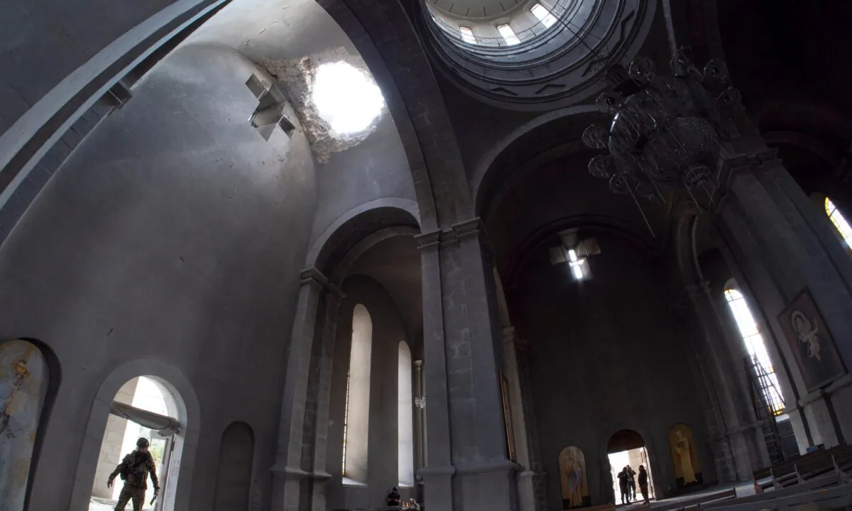 A hole made by shell in the roof of the Holy Savior Cathedral during a military conflict, in Shushi, outside Stepanakert, self-proclaimed Republic of Nagorno-Karabakh, on Oct. 8, 2020. Armenia accused Azerbaijan of firing missiles into the capital of the separatist territory of Nagorno-Karabakh, while Azerbaijan said several of its towns and its second-largest city were attacked. (AP Photo)