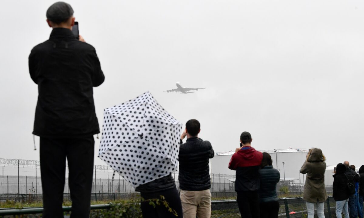 Spectators take images of a British Airways Boeing-747