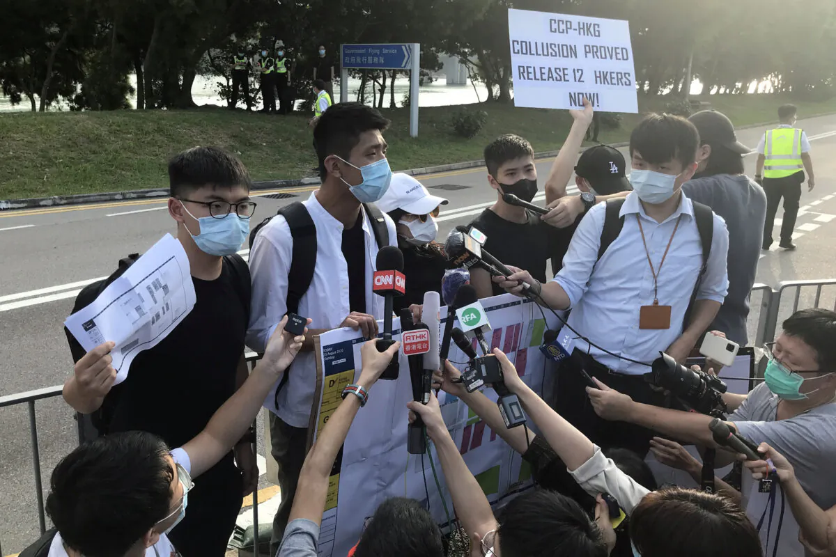 Pro-democracy activists Joshua Wong, Owen Chow, and family members of twelve Hong Kong activists arrested as they reportedly sailed to Taiwan for political asylum, speak to media after a protest outside the headquarters of Government Flying Service, in Hong Kong, on October 8, 2020. (Aleksander Solum/Reuters)