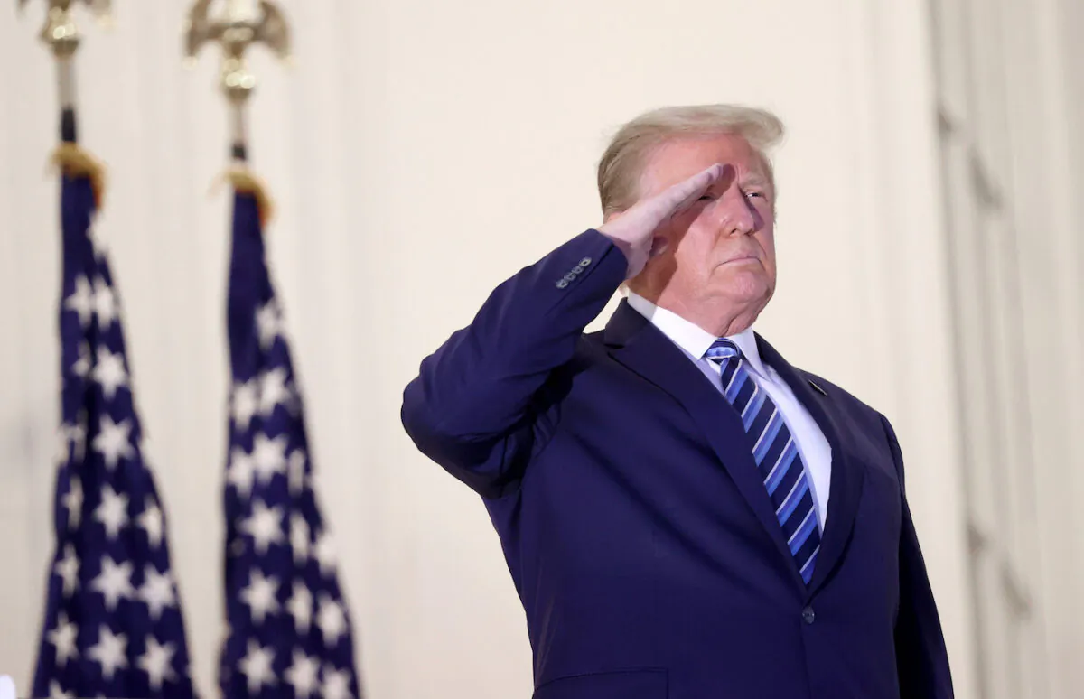 President Donald Trump salutes Marine One helicopter pilots after returning to the White House from Walter Reed National Military Medical Center in Washington, on Oct. 5, 2020. (Win McNamee/Getty Images)