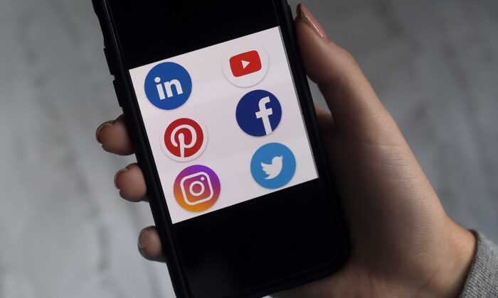 This illustration picture shows social media applications logos from Linkedin, YouTube, Pinterest, Facebook, Instagram, and Twitter displayed on a smartphone in Arlington, Va., on May 28, 2020. (Olivier Douliery/AFP via Getty Images)