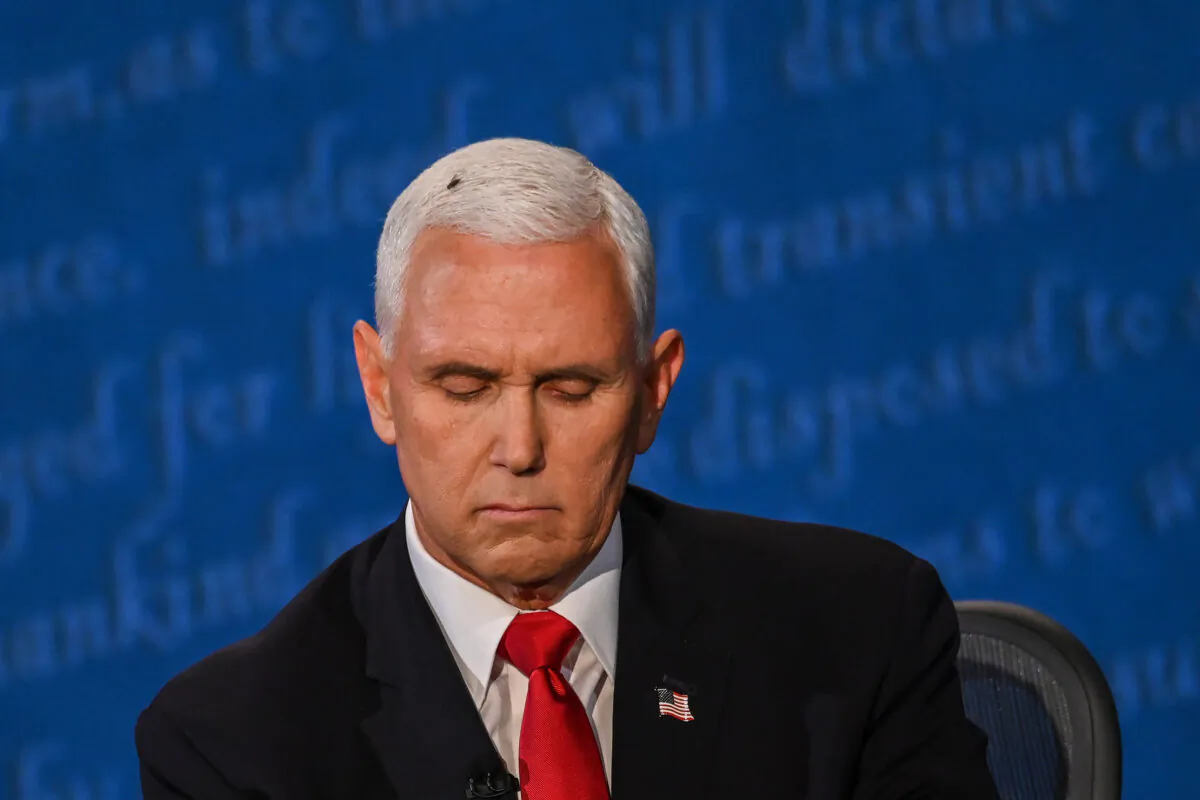 A fly rests on the head of Vice President Mike Pence as he takes notes during the vice presidential debate against Democratic vice presidential nominee and Senator from California Kamala Harris in Kingsbury Hall at the University of Utah in Salt Lake City, Utah on Oct. 7, 2020. (Eric Baradat/AFP via Getty Images)