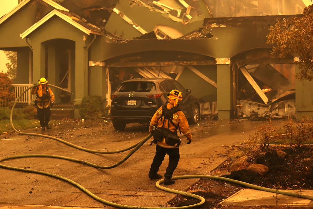 Firefighters mop up hot spots at a home that was destroyed by a wildfire in Santa Rosa, Calif., on Sept. 28, 2020. (Justin Sullivan/Getty Images)