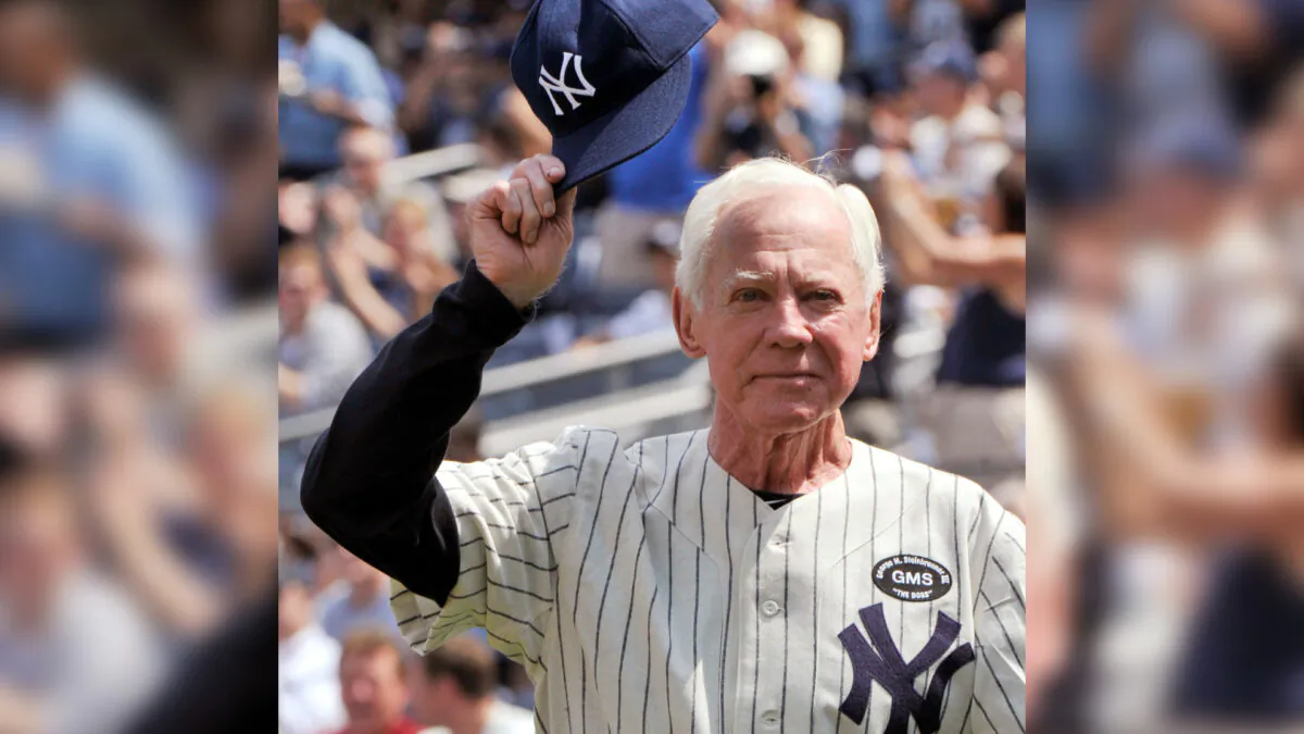 Hall of Fame member Whitey Ford tips his cap during introductions for the New York Yankees 64th Old-Timers' Day game before they played the Tampa Bay Rays in their MLB American League baseball game at Yankee Stadium in New York City, on July 17, 2010. (Ray Stubblebine/Reuters)