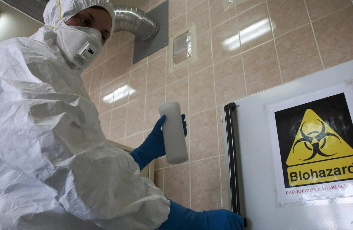 A Russian laboratory worker handles a vial containing the swine flu virus H1N1 strain in St. Petersburg on May 13, 2009. (Kirill Sirotyuk/AFP via Getty Images)