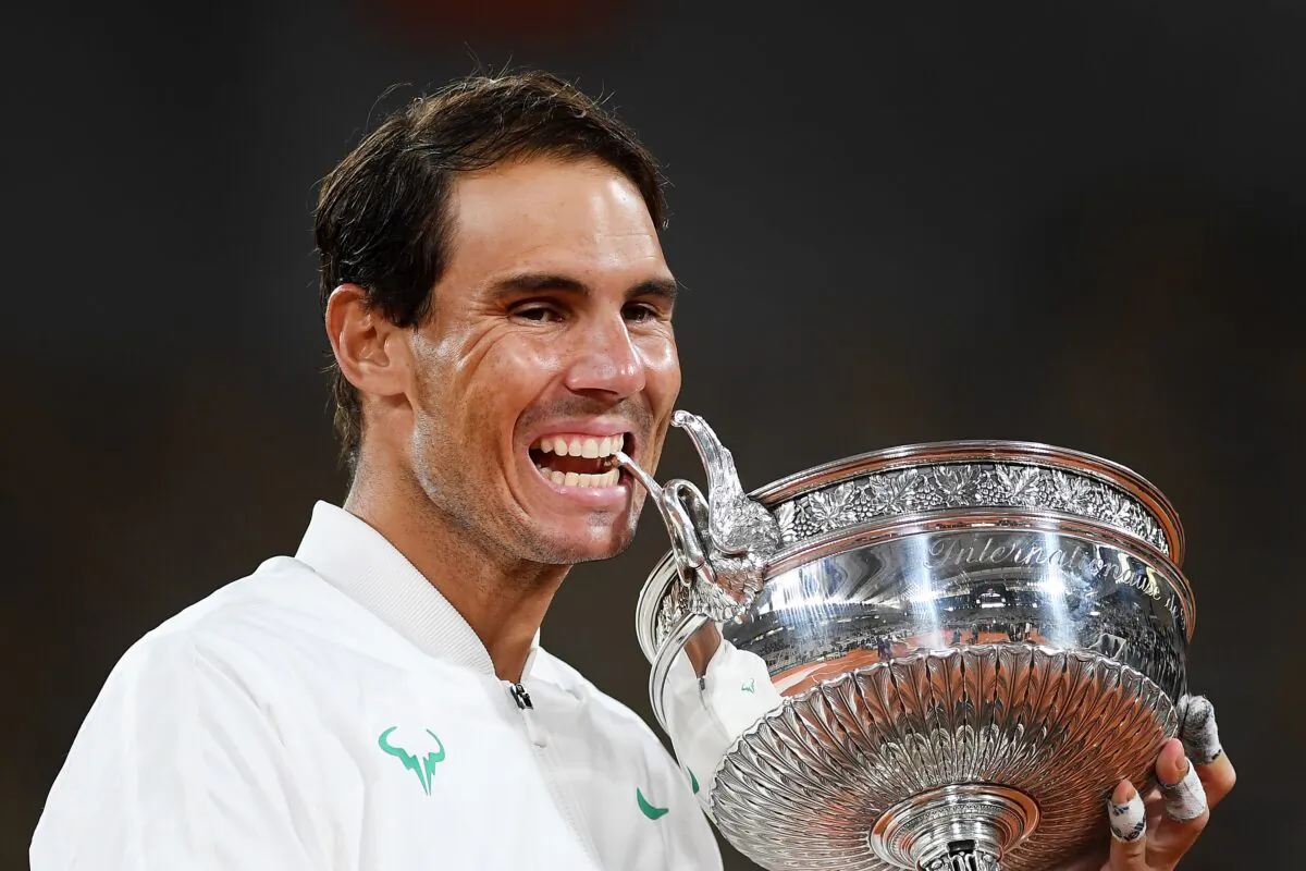 Rafael Nadal of Spain bites the winners trophy following victory in his Men's Singles Final against Novak Djokovic of Serbia on day fifteen of the 2020 French Open at Roland Garros, in Paris, France on Oct. 11, 2020. (Shaun Botterill/Getty Images)