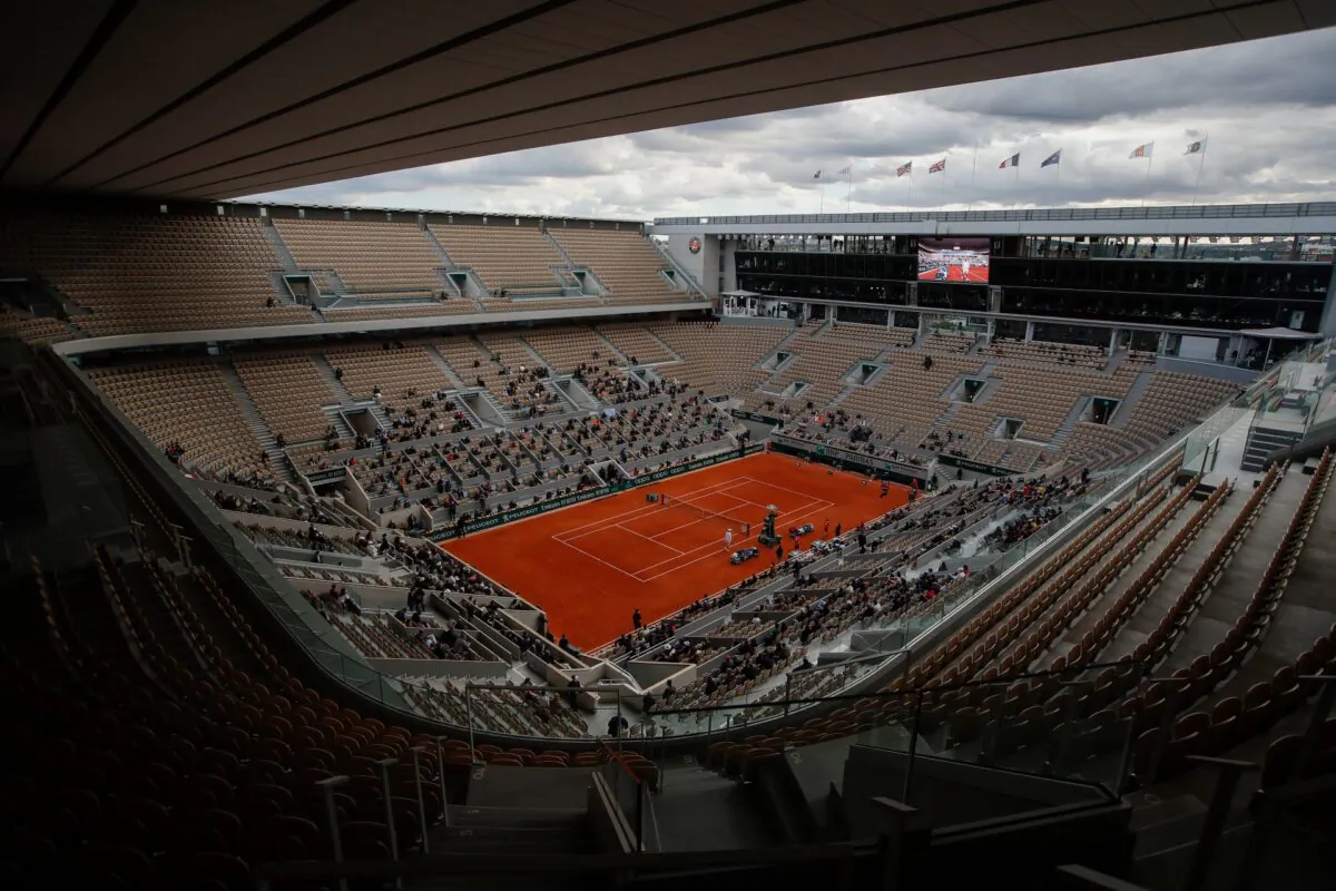 Rows of empty seats are seen at center court Philippe Chatrier as Serbia's Novak Djokovic and Spain's Rafael Nadal warm up for the final match of the French Open tennis tournament at the Roland Garros stadium in Paris, France, on Oct. 11, 2020. (Alessandra Tarantino/AP Photo)
