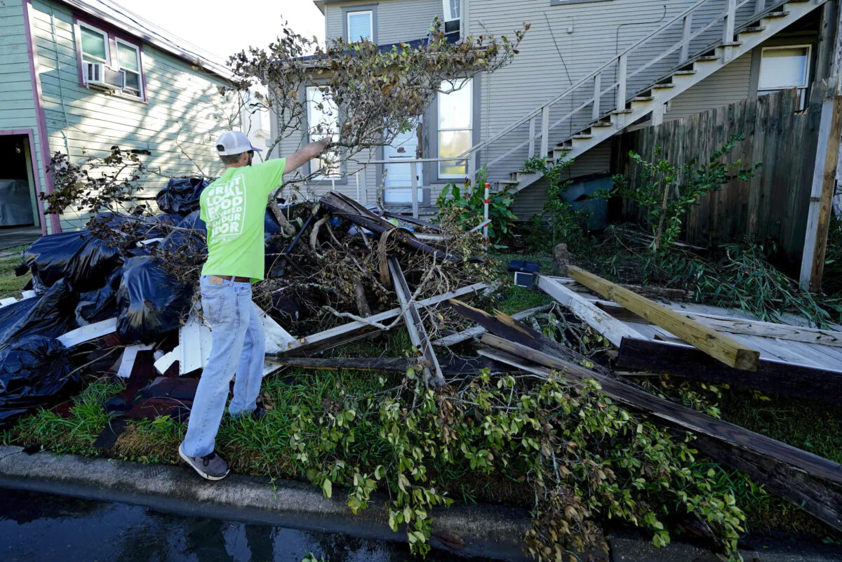 Caleb Cormier moves debris after Hurricane Delta moved through, in Lake Charles, La., on Oct. 10, 2020. (Gerald Herbert/AP Photo)