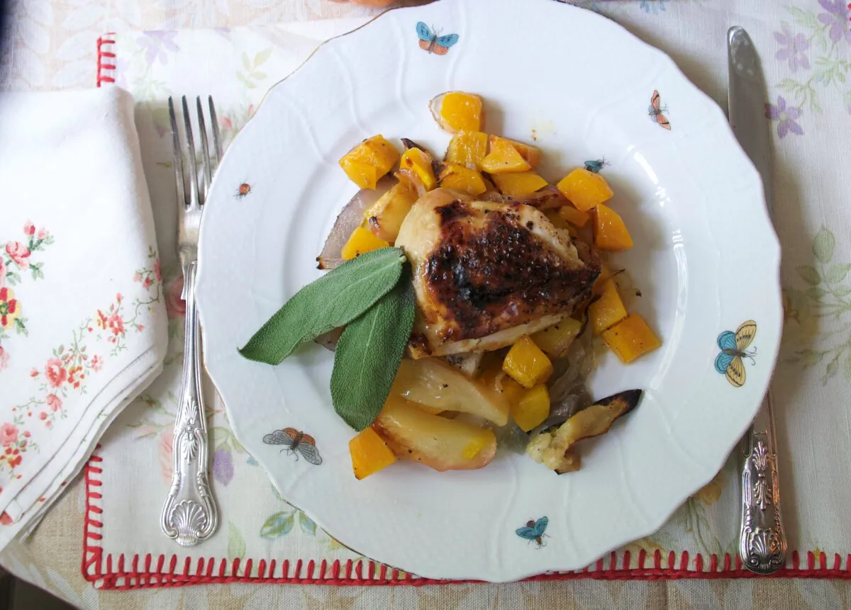 As the chicken thighs roast, they release their juices and fat to mingle with the caramelizing squash and apples on the same pan. (Victoria de la Maza)