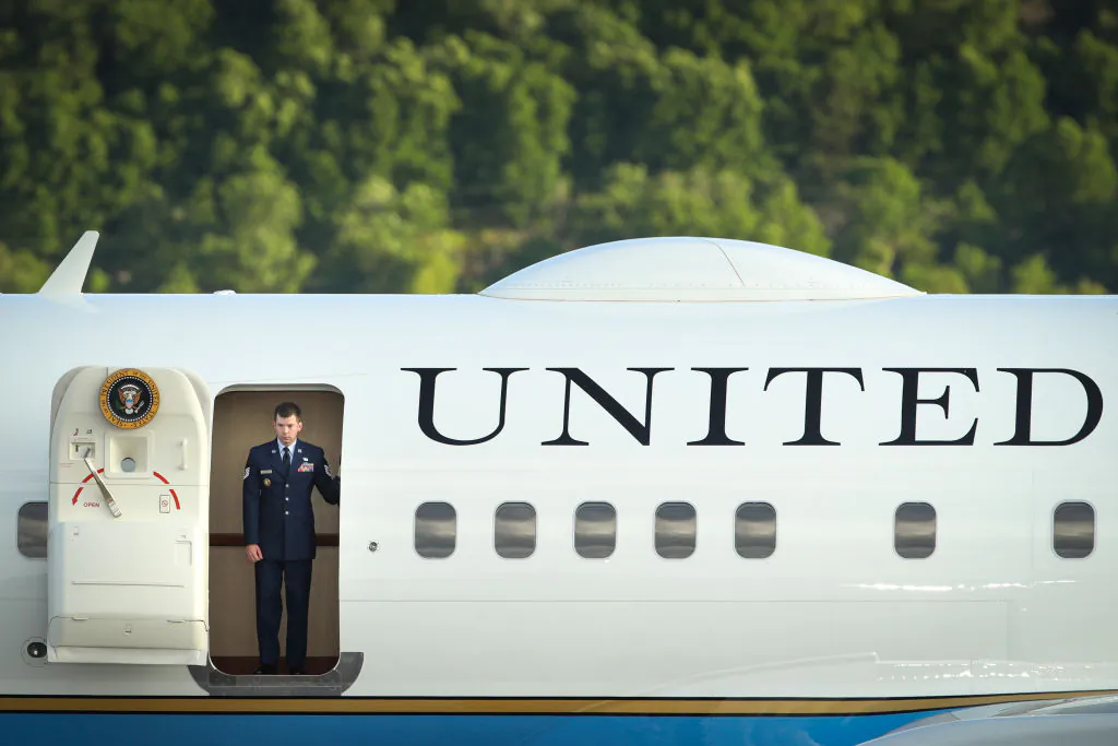 A member of the U.S. Air Force peers out the door as Air Force One arrives at Williamsport Regional Airport, May 20, 2019, in Montoursville, Penn.  (Drew Angerer/Getty Images)