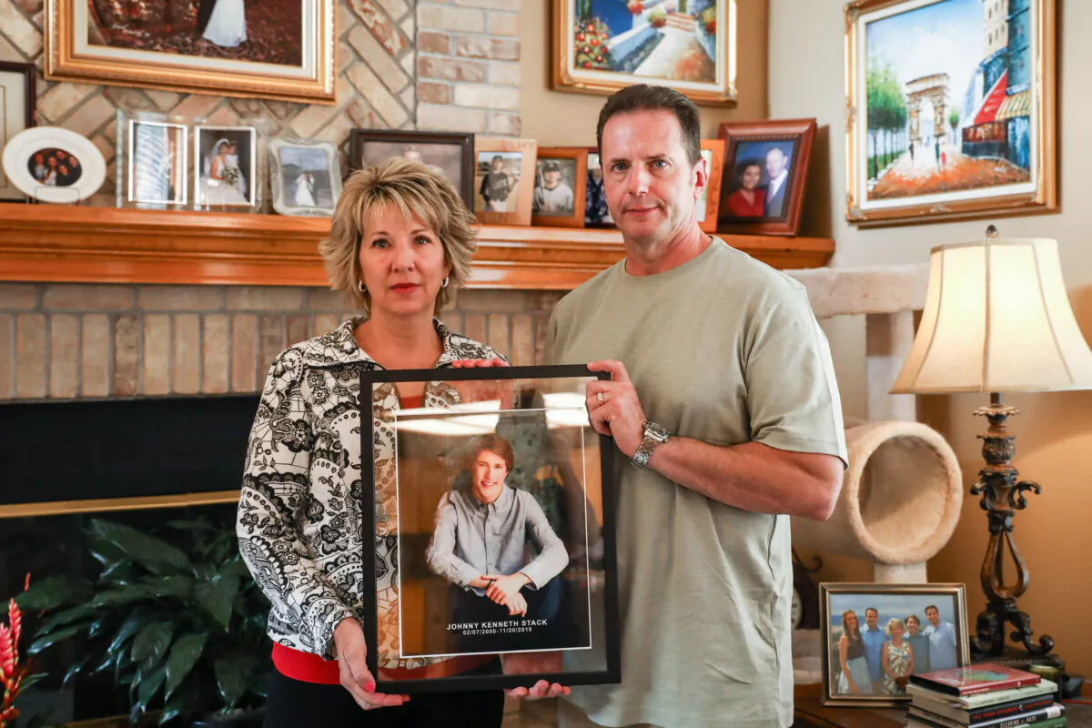 Laura and John Stack hold a memorial photo of their son, Johnny, in their home at Highlands Ranch, in southern Denver, Colo., on Oct. 1, 2020. (Charlotte Cuthbertson/The Epoch Times)