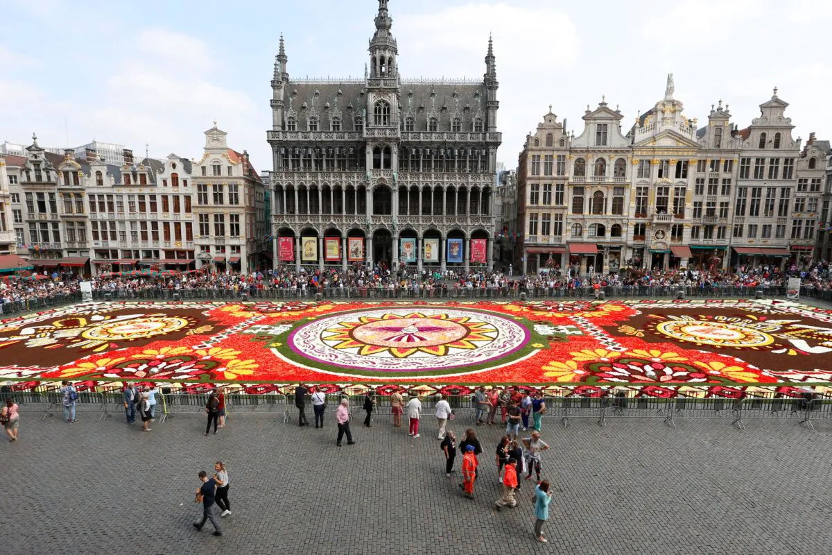 The installation of the annual flower carpet on the Grand Place in the city center of Brussels on Aug. 16, 2018. (NICOLAS MAETERLINCK/AFP via Getty Images)