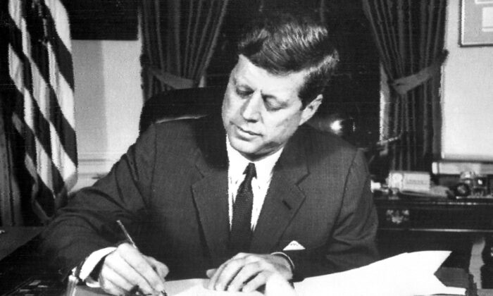 U.S. President John F. Kennedy signs the order for a naval blockade of Cuba on Oct. 24, 1962, during the Cuban Missile Crisis. (AFP via Getty Images)