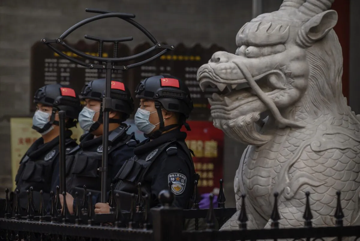 Chinese security stand guard in a shopping area in Beijing on Oct. 8, 2020. (Kevin Frayer/Getty Images)