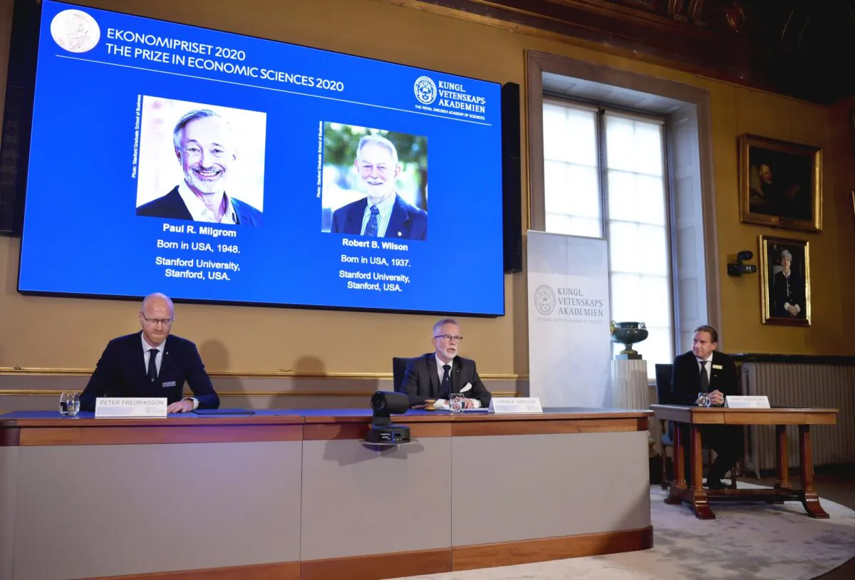 Peter Fredriksson, Chairman of the Committee for Economic Sciences, left, Goran K. Hansson, Permanent Secretary for the Royal Swedish Academy of Sciences, center, and Tommy Andersson, member in The Prize Committee for the Alfred Nobel Memorial Prize in Economic Sciences announce the Sveriges Riksbank Prize in Economic Sciences in Memory of Alfred Nobel for 2020 at a press conference in Stockholm on Oct. 12, 2020. (Anders Wiklund/TT via AP)