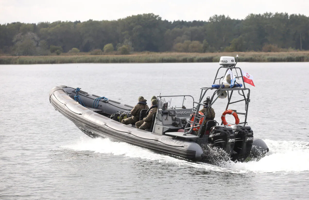 Navy divers from the 12th Minesweeper Squadron of the 8th Coastal Defense Flotilla take part in a five-day operation to defuse the largest unexploded World War Two Tallboy bomb ever found in Poland in Swinoujscie, Poland, on Oct. 12, 2020. (Agencja Gazeta/Cezary Aszkielowicz via Reuters) 