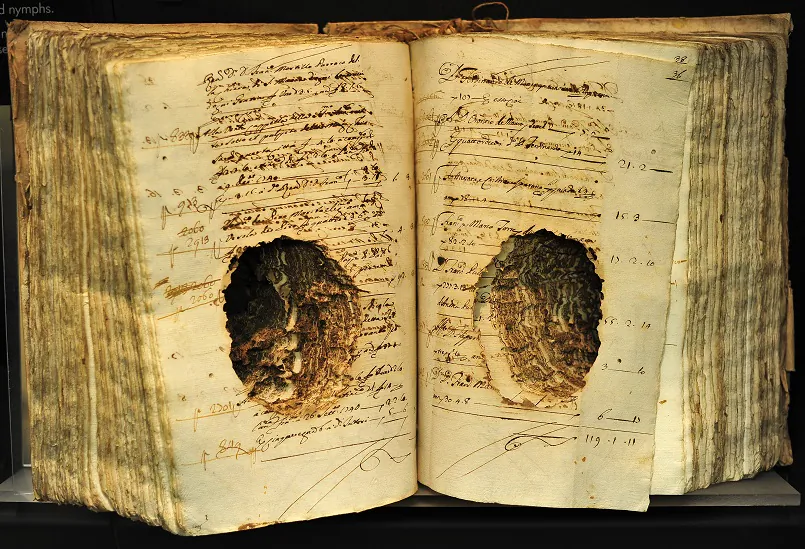 Books damaged by termites are displayed on a shelf of the museum at the Central Institute for the Conservation and Restoration of Damaged Books in Rome on Dec. 20, 2011 in Rome. (Alberto Pizzoli/AFP via Getty Images)