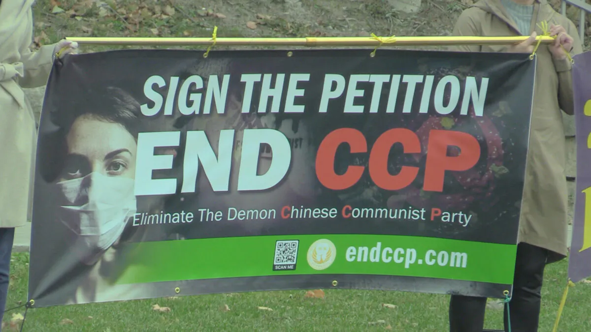 Volunteers hold a banner calling for an end to the Chinese Communist Party (CCP) in Toronto on Oct. 10 and Oct. 11 (NTD Television)