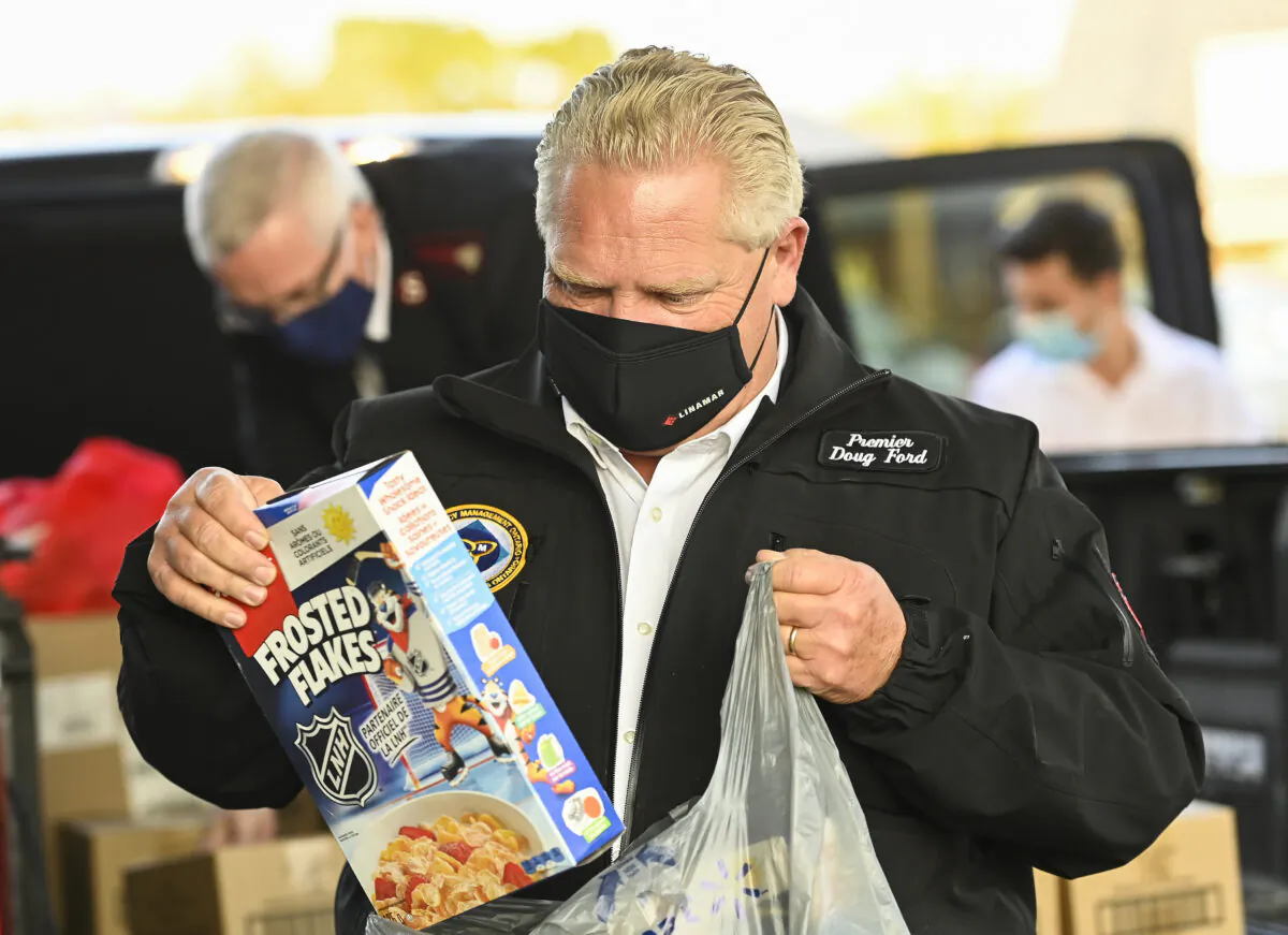 Ontario Premier Doug Ford delivers food at the Salvation Army food bank during the COVID-19 pandemic in Toronto on Oct. 9, 2020. (Nathan Denette/The Canadian Press)